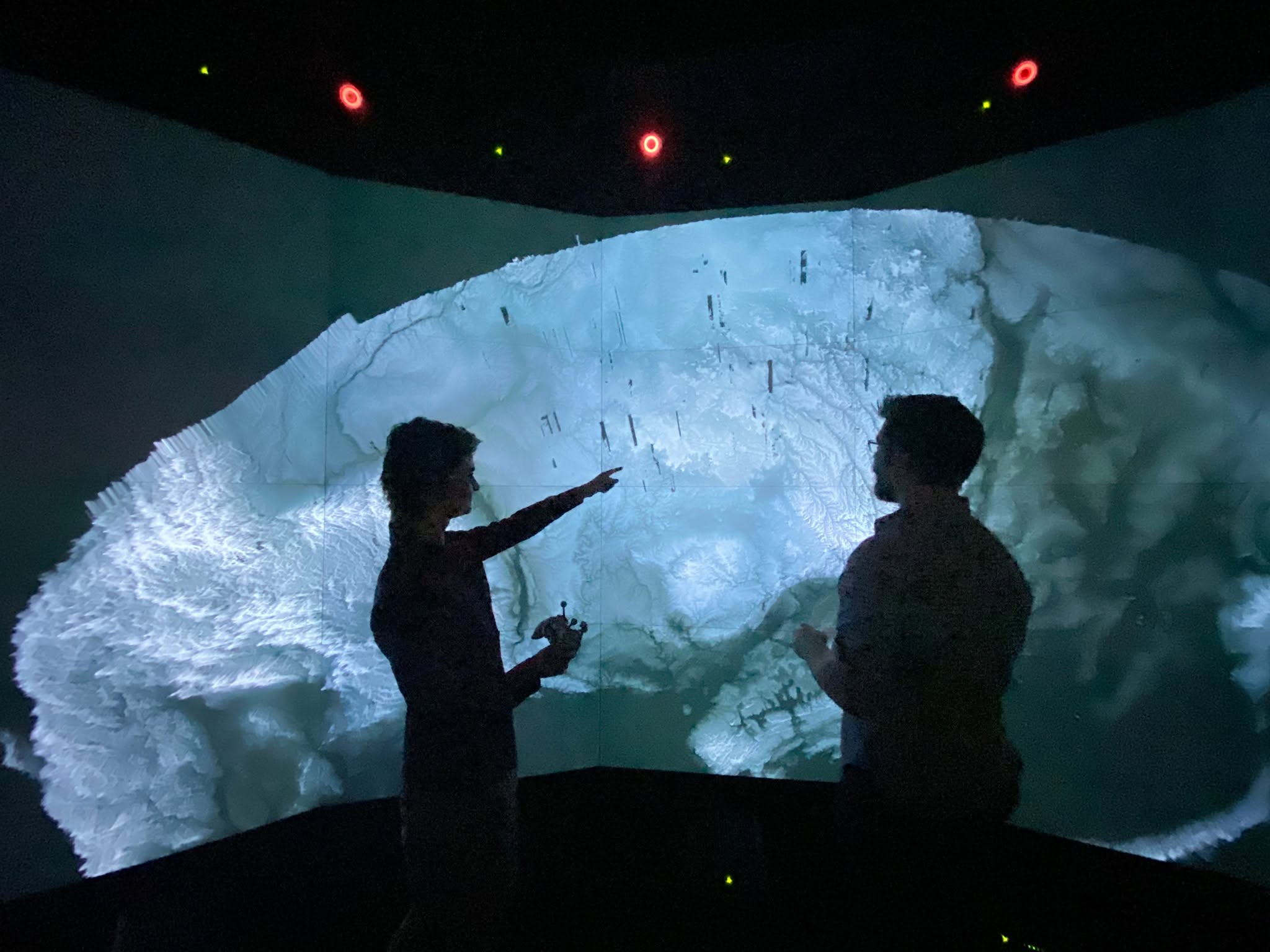 Kalina Borkiewicz and a colleague examining an immersive scientific visualization