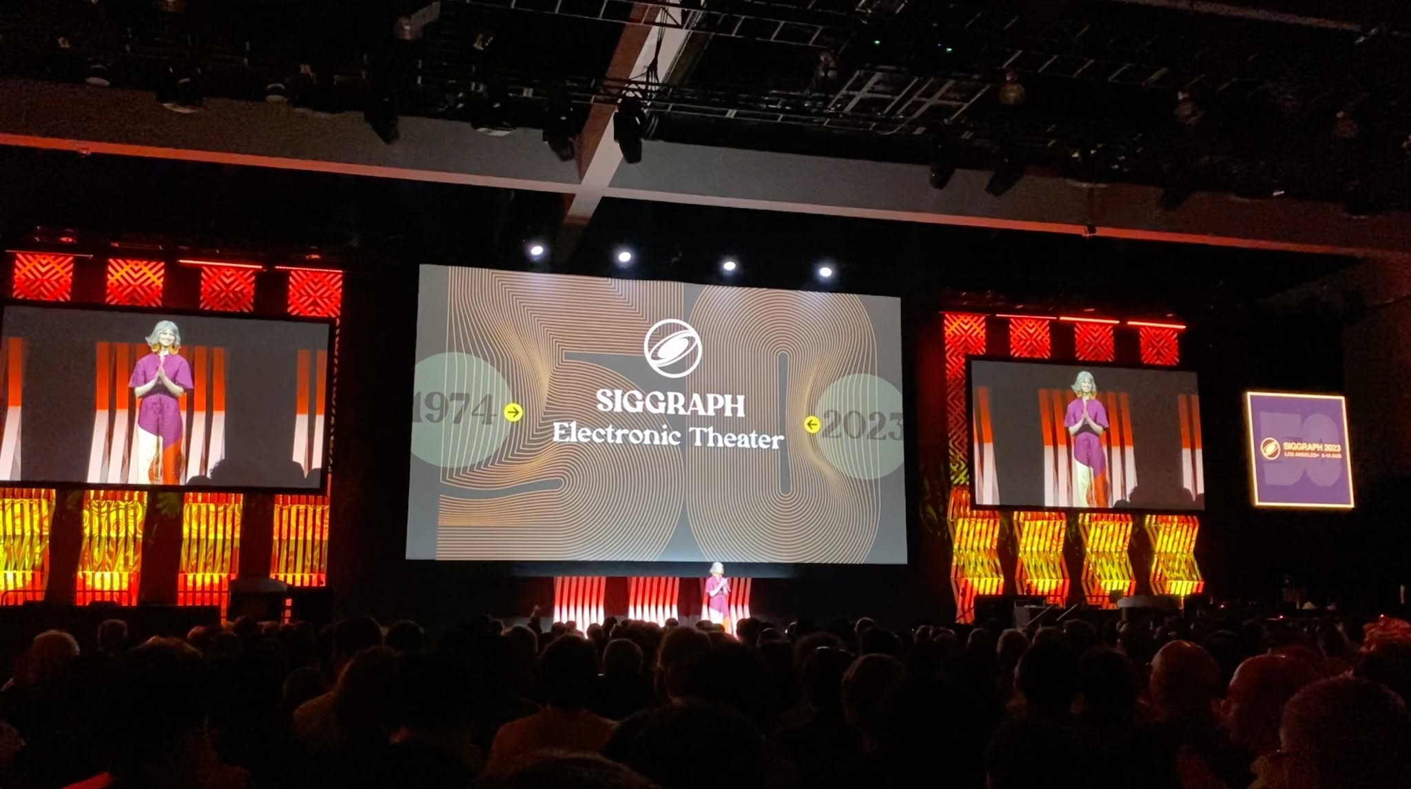 Kalina Borkiewicz directing the SIGGRAPH 2023 Electronic Theater on a large stage